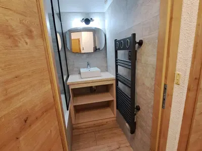 a small bathroom with a sink and a mirror at Appartement 2 pièces au pied de la télécabine avec animaux admis et parking - FR-1-836-30 in Arâches-la-Frasse