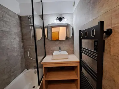 a bathroom with a sink and a mirror and a tub at Appartement 2 pièces au pied de la télécabine avec animaux admis et parking - FR-1-836-30 in Arâches-la-Frasse
