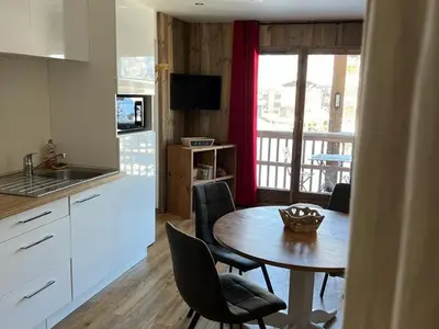 a kitchen and dining room with a table and chairs at Appartement moderne en centre-ville avec parking et animaux admis - 6 pers. - FR-1-836-49 in Arâches-la-Frasse