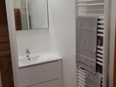 a white bathroom with a sink and a mirror at Appartement moderne en centre-ville avec parking et animaux admis - 6 pers. - FR-1-836-49 in Arâches-la-Frasse