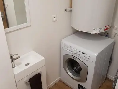 a washing machine in a bathroom next to a sink at Appartement moderne en centre-ville avec parking et animaux admis - 6 pers. - FR-1-836-49 in Arâches-la-Frasse