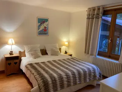 a bedroom with a bed and a window at Chalet cosy 6 chambres, 14 pers, proche télécabine, parking, non fumeur - FR-1-836-28 in Arâches-la-Frasse