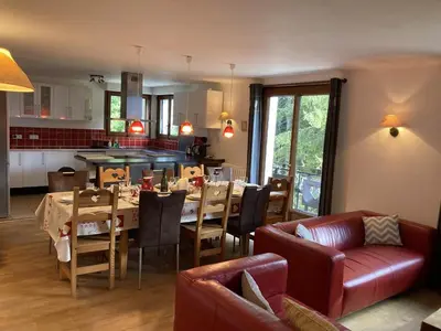 a dining room and kitchen with a table and chairs at Chalet cosy 6 chambres, 14 pers, proche télécabine, parking, non fumeur - FR-1-836-28 in Arâches-la-Frasse