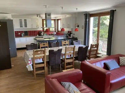 a kitchen and living room with a table and chairs at Chalet cosy 6 chambres, 14 pers, proche télécabine, parking, non fumeur - FR-1-836-28 in Arâches-la-Frasse