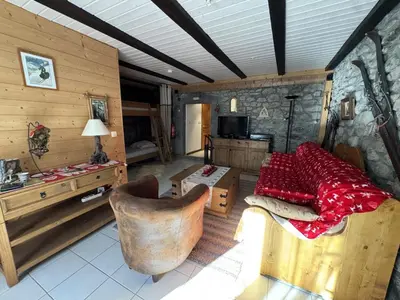 a living room with a couch and a bed in a room at Appartement de charme dans chalet rénové - Animaux et parking - FR-1-836-54 in Arâches-la-Frasse