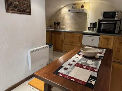 a kitchen with a wooden table with a bowl on it at Appartement de charme dans chalet rénové - Animaux et parking - FR-1-836-54 in Arâches-la-Frasse