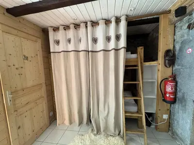 a shower curtain in a room with a ladder at Appartement de charme dans chalet rénové - Animaux et parking - FR-1-836-54 in Arâches-la-Frasse