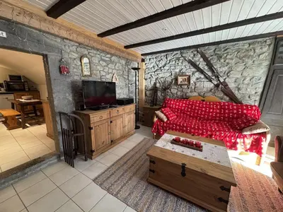 a living room with a couch and a tv at Appartement de charme dans chalet rénové - Animaux et parking - FR-1-836-54 in Arâches-la-Frasse