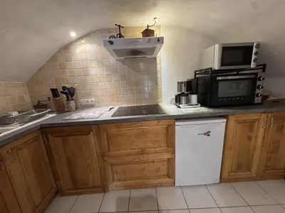 a kitchen with a sink and a microwave and a refrigerator at Appartement de charme dans chalet rénové - Animaux et parking - FR-1-836-54 in Arâches-la-Frasse