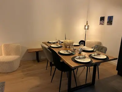 a dining room table with plates and glasses on it at Nouveau ! Appartement de standing 3 chambres avec balcon et parking couvert - FR-1-836-42 in Arâches-la-Frasse