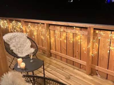 a deck with a fence with lights on it at Nouveau ! Appartement de standing 3 chambres avec balcon et parking couvert - FR-1-836-42 in Arâches-la-Frasse