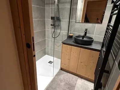 a bathroom with a sink and a glass shower at Nouveau ! Appartement de standing 3 chambres avec balcon et parking couvert - FR-1-836-42 in Arâches-la-Frasse