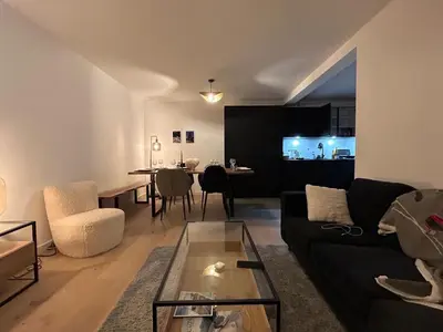 a living room with a black couch and a table at Nouveau ! Appartement de standing 3 chambres avec balcon et parking couvert - FR-1-836-42 in Arâches-la-Frasse