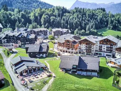 a hotel in the snow with cars parked in a parking lot at Studio à Morillon pour 4 pers. proche pistes et commerces - FR-1-815-105 in Morillon