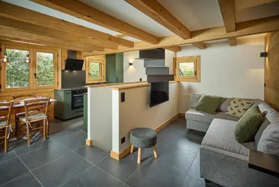 a kitchen and living room with a couch and a table at Chalet Juno - Chamonix All Year in Chamonix-Mont-Blanc