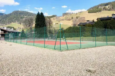 a tennis court with a fence on top of it at Superb apartment in Megève in Megève