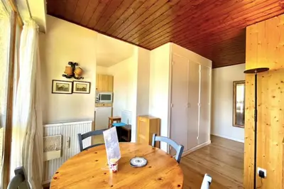 a dining room with a wooden table and chairs at Superb apartment in Megève in Megève