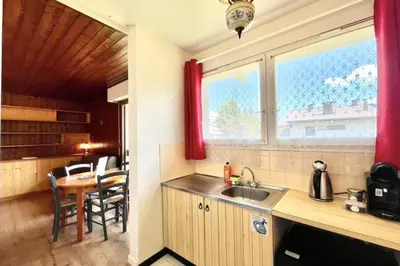 a kitchen with a sink and a table and a window at Superb apartment in Megève in Megève