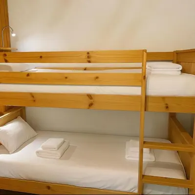 a room with bunk beds with white towels at Bright apartment for 6 people in Chamonix in Chamonix-Mont-Blanc