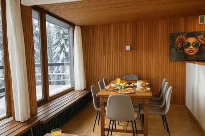 a dining room with a table and chairs and a window at Bright apartment for 6 people in Chamonix in Chamonix-Mont-Blanc