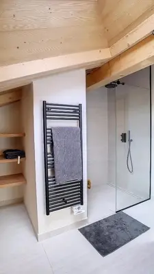 a bedroom with a bed in a room with wooden ceilings at Chalet des Pres- 3 chambres - JAILLET - in Demi-Quartier