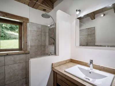 a bedroom with a bed in a room with wooden walls at Chalet à Saint-Gervais-les-Bains, 11 pers, sauna, Wi-Fi, parking - FR-1-663-59 in Saint-Gervais-les-Bains