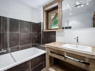 a living room with a couch and a flat screen tv at Chalet à Saint-Gervais-les-Bains, 11 pers, sauna, Wi-Fi, parking - FR-1-663-59 in Saint-Gervais-les-Bains