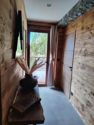a room with a large window and a wooden wall at La Tanière des Cimes, sauna privé in Passy