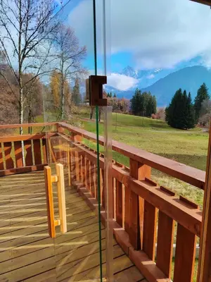 a glass door on a deck with a view at La Tanière des Cimes, sauna privé in Passy