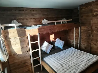 a bunk bed with two bunk beds in a room at La Tanière des Cimes, sauna privé in Passy