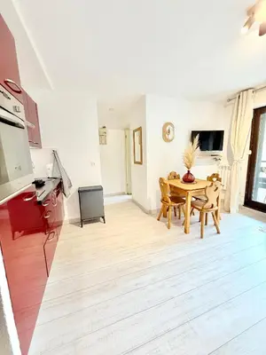 a living room with a table and a dining room at Le Gemma in Saint-Gervais-les-Bains