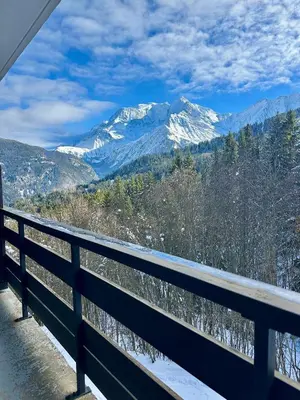 a view of a snow covered mountain from a balcony at Le Gemma in Saint-Gervais-les-Bains