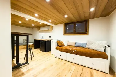 a room with a bed in the middle of a kitchen at Apartment with garden and proximity to activities in Chamonix-Mont-Blanc