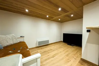 a living room with a couch and a flat screen tv at Apartment with garden and proximity to activities in Chamonix-Mont-Blanc