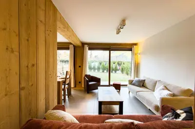 a living room with a couch and a table at Apartment with garden and proximity to activities in Chamonix-Mont-Blanc