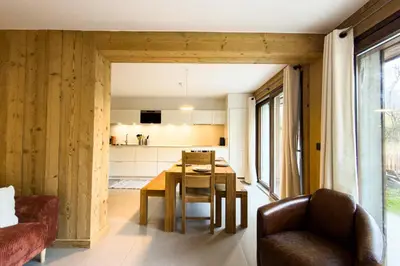 a kitchen and dining room with a table and chairs at Apartment with garden and proximity to activities in Chamonix-Mont-Blanc
