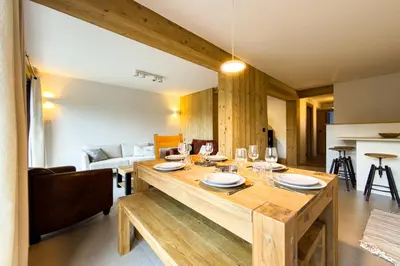 a living room with a wooden table with glasses on it at Apartment with garden and proximity to activities in Chamonix-Mont-Blanc