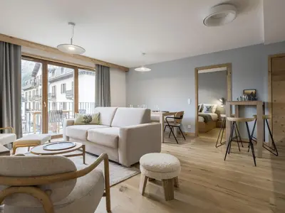 a living room with a white couch and a table at White Dream - Vue et confort en centre-ville in Chamonix-Mont-Blanc