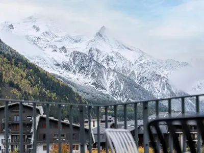 a view of a snow covered mountain from a balcony at White Dream - Vue et confort en centre-ville in Chamonix-Mont-Blanc