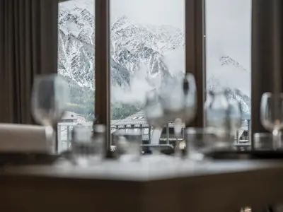 a table with wine glasses in front of a window at White Dream - Vue et confort en centre-ville in Chamonix-Mont-Blanc
