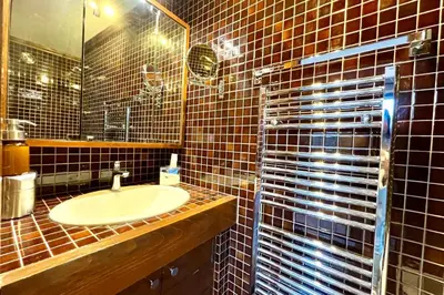 a bathroom with a sink and a mirror at Bright apartment with balcony and pool in Megève