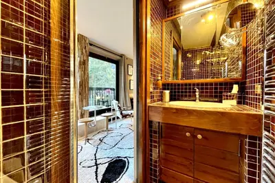 a bathroom with a sink and a mirror at Bright apartment with balcony and pool in Megève