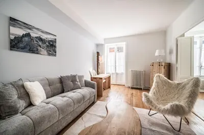 a living room with a couch and a table at Apartment Brina Chamonix - by EMERALD STAY in Chamonix-Mont-Blanc
