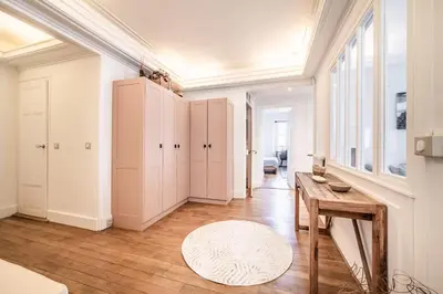 a room with white cabinets and a wooden table at Apartment Brina Chamonix - by EMERALD STAY in Chamonix-Mont-Blanc
