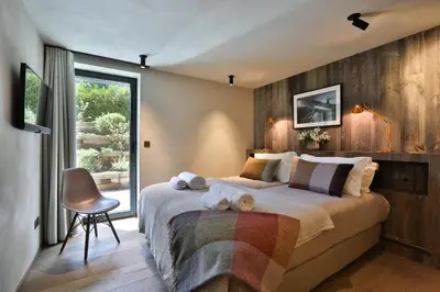 a bedroom with a large bed and a window at Chalet onthe Rocks in Chamonix-Mont-Blanc