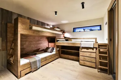 two bunk beds in a room with wooden walls at Chalet onthe Rocks in Chamonix-Mont-Blanc