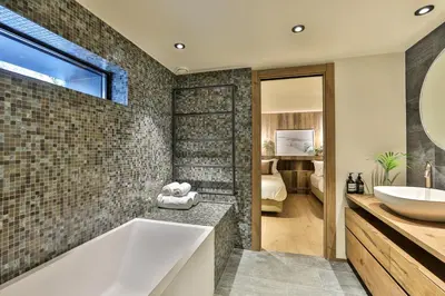 a bathroom with a tub and a sink at Chalet onthe Rocks in Chamonix-Mont-Blanc