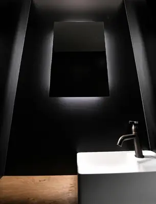 a black bathroom with a sink and a mirror at Chalet onthe Rocks in Chamonix-Mont-Blanc