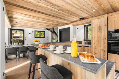 an open kitchen with a counter with food on it at Chalet Larzay - Chamonix in Chamonix-Mont-Blanc