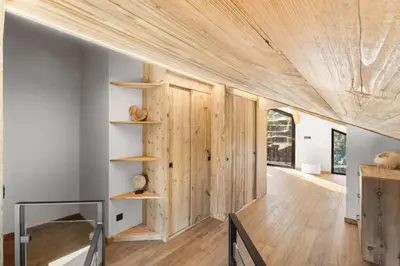 a room with wood paneling and a wall with shelves at Chalet Larzay - Chamonix in Chamonix-Mont-Blanc